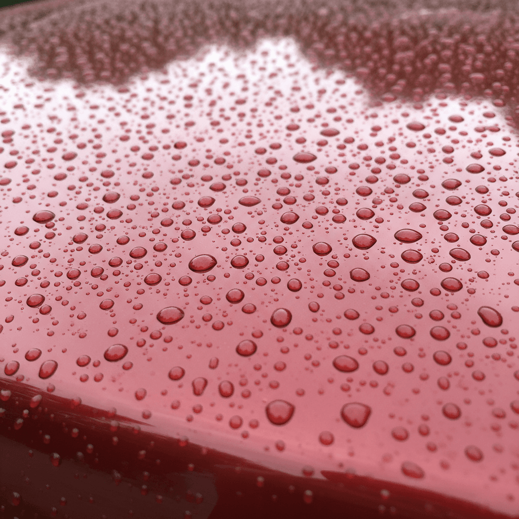 Water beads on ceramic coated red sedan